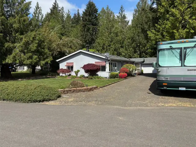 Front of home with RV parking.