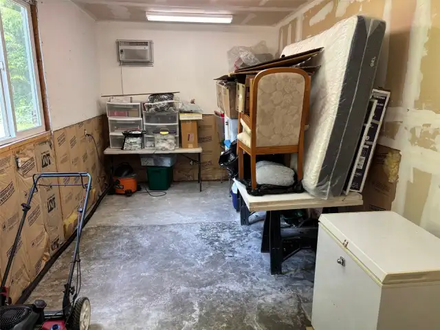 Shop space in garage showing freezer.