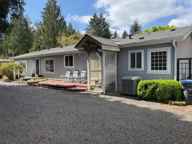 Front, covered entry with concrete steps  and a lovely deck.