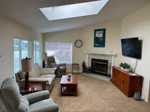 Living Room with fireplace and skylight.