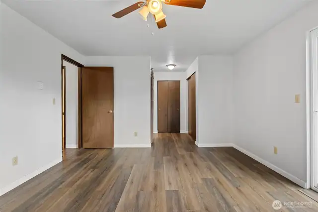 Another angle of the primary bedroom. 2 closets and a 3/4 bath