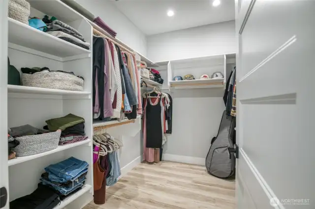 Large walk-in closet with custom shelving in the primary bedroom