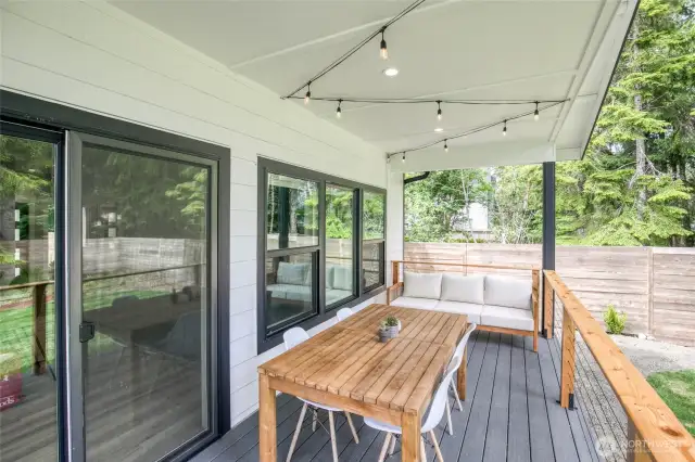 Covered back porch with Trex deck, custom wire railing and decorative lighting