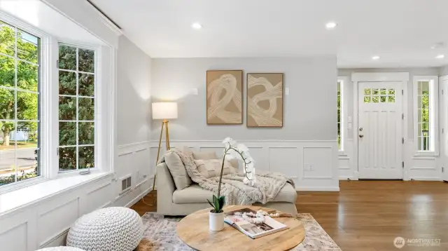 No details were missed. Look at that elegant wainscoting and sunny bay windows