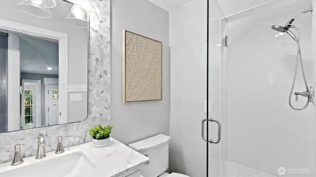 Powder room with a shower right at the front door.
