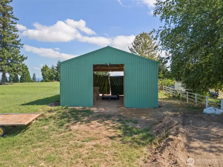 Back of large outbuilding currently set up for hay storage.