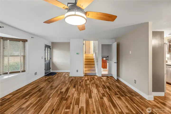 MAIN LEVEL LIVING ROOM | Up the stairs are the three bedrooms with a guest bathroom and en-suite off the primary bedroom. Down the stairs you'll find the huge rec room.