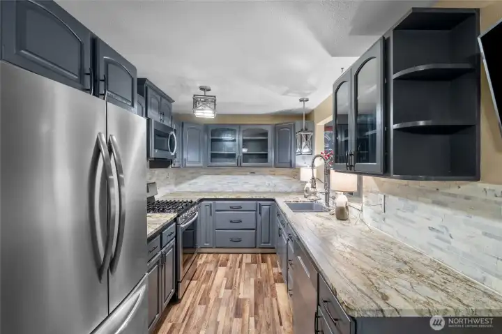KITCHEN | Enjoy updated finishes in the cute galley kitchen located between the living room at the front of the home and dining room at the back of the home.