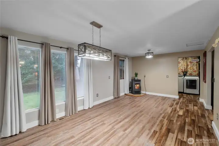 DINING ROOM | You'll love the size of this generous dining room and appreciate the windows looking onto the backyard. In the corner is a pellet stove for cozy heat.