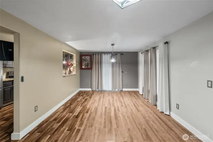 DINING ROOM | Another view of the dining room. Behind the curtains is a sliding glass door that leads out to the backyard.