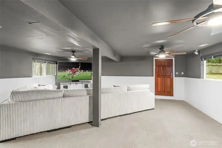 LOWER LEVEL | This huge rec room is perfect for large gatherings! With a door that leads to the backyard and lots of windows to let in light, this is a room you'll want to live in.