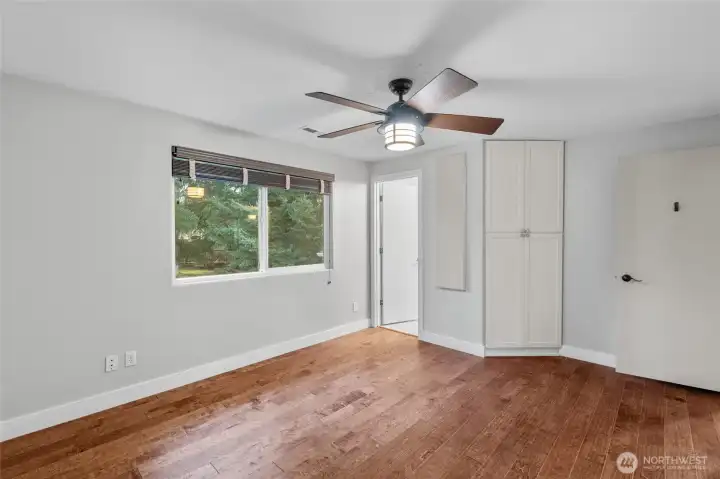 PRIMARY BEDROOM | This room is located at the end of the hallway on the upper level and overlooks the backyard. The door leads to an attached bathroom.
