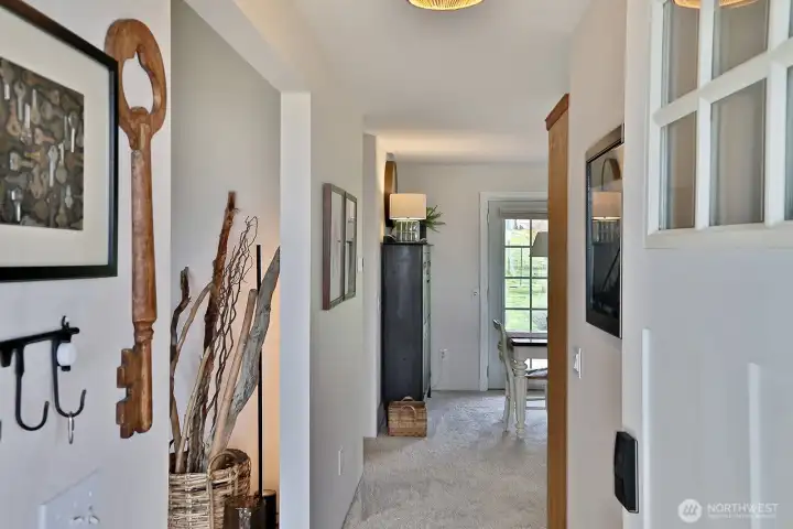 The entry hall leads straight into the open dining, kitchen and family room area.  The opening on the left leads into the living room.