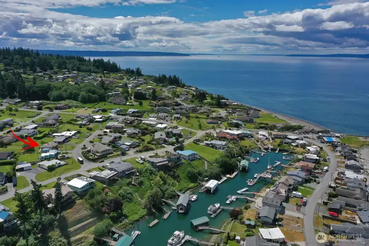 Aerial showing Subject and its proximity to the community pool, seaside to the right in the photo, etc.