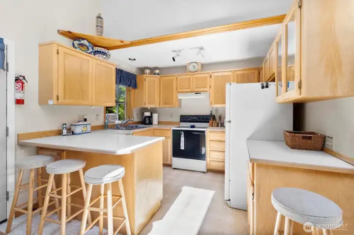 Kitchen view showcasing the open layout to living and dining areas.