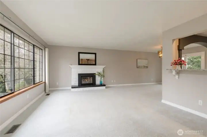 Bright living room on the main level with an elegant gas fireplace