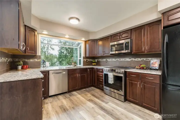 Enjoy quartz counters, tiled backsplash, and a large garden window