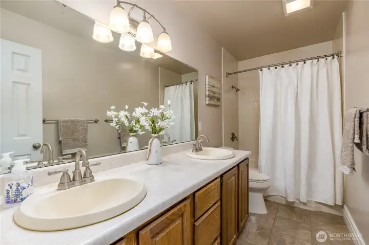 Full upstairs bathroom with dual sinks