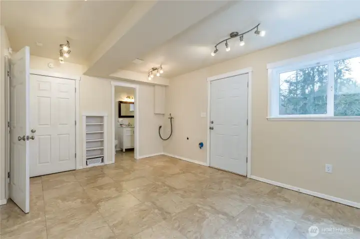 Utility/flex room/potential 5th bedroom on the lower level has a half bath, laundry hookups and back patio access.