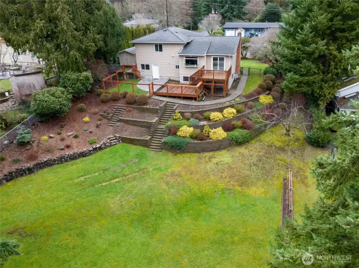 Beautiful terracing makes good use of this slightly sloped property. Note the mini orchard on the right side of the photo: apples, plum, raspberries, grapes and blueberries!