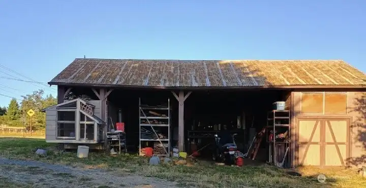 Barn/storage and extra parking with a finished area on the right end behind the doors.