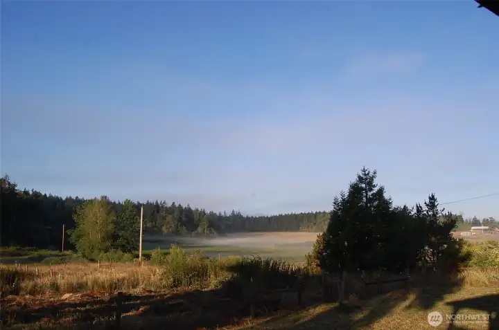 Fog has almost dissipated and mountains are becoming visible in the distance.