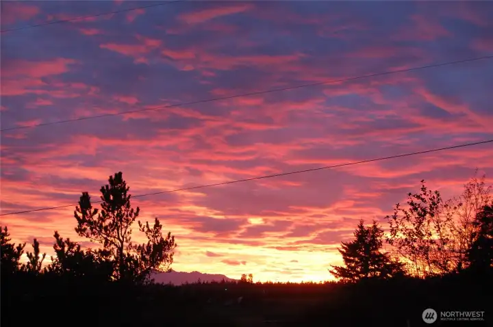 Spectacular sunset fills the sky above your soon to be home in picturesque Port Townsend.