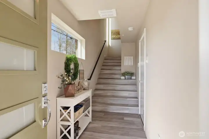 An inviting entryway and access to the attached garage are on the ground level, with all living areas and bedrooms up above for perfect privacy.
