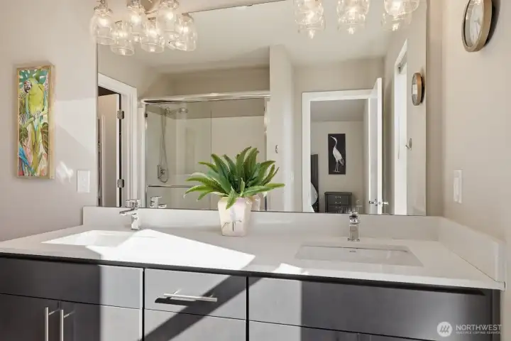 Dual vanities, a glass walk-in shower, stylish fixtures - wow!
