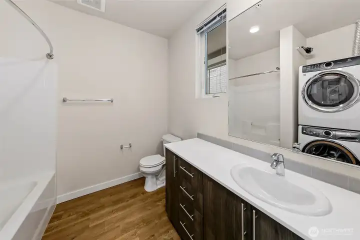 Full bathroom with laundry, nice layout and space for this modern build. Notice the water meter above the laundry room, each unit is individually metered.