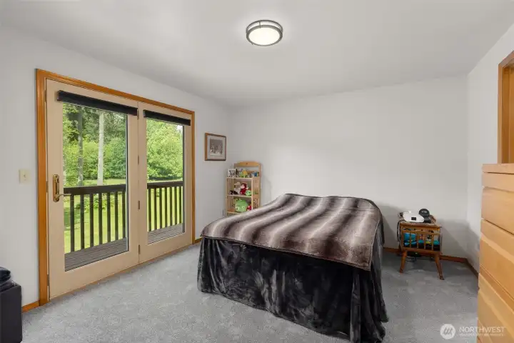 Main level bedroom with slider to deck and shared attached ensuite.