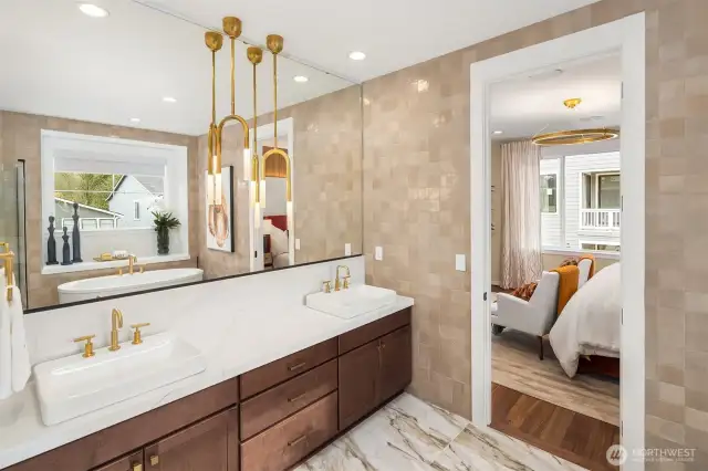 Primary bath showcases floor to ceiling tiled walls, 3cm quartz countertop, Kohler Vox vanity sinks & pendant lights