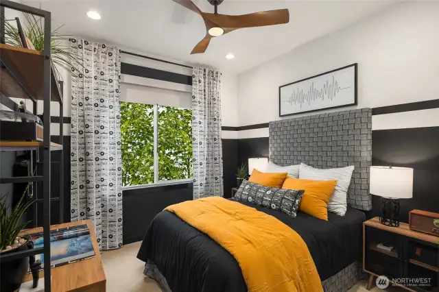 Top floor secondary bedroom with painted ebony wood wall finishes & ceiling fan fixture