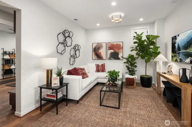 Main floor flex area with white brick tile walls offers versatile living options