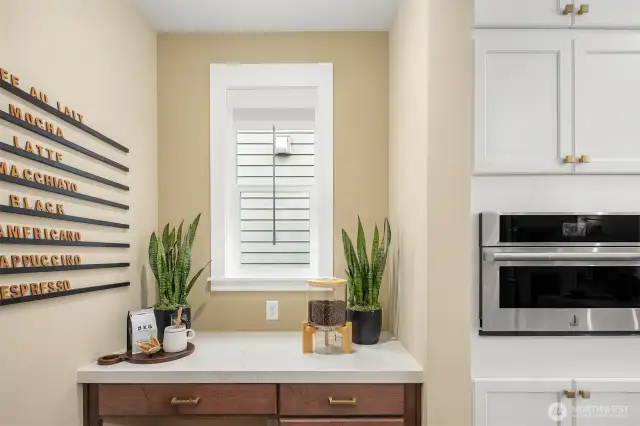 Adjacent workspace/bar off of kitchen provide additional storage