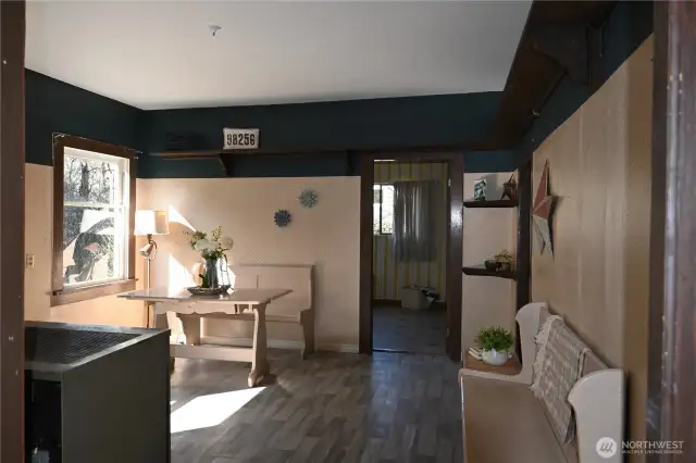 Tall ceilings, wood shelving and LVP flooring. Wood stove to left of photo.