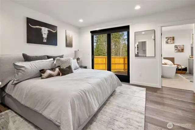 spacious primary with slider to paver patio