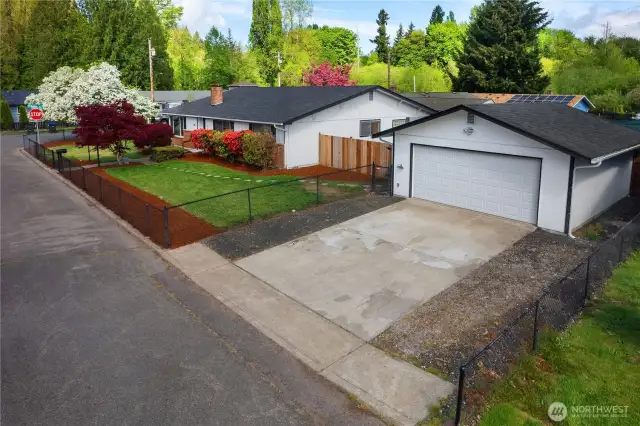 Detached shop/garage with driveway, power and automatic opener.