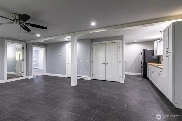 The lower level, fridge with counter space and sink, washer and dryer are behind the double doors