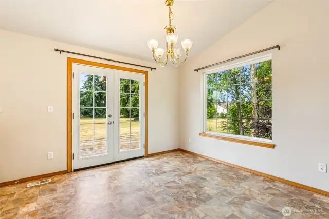 Dining with French Doors to the Backyard & Deck