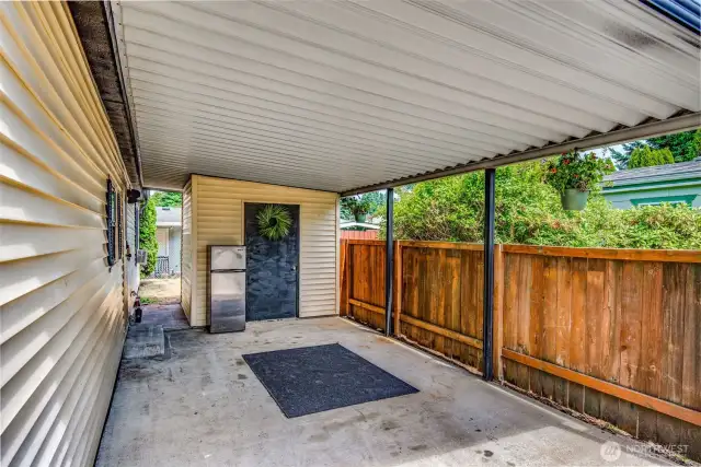 Covered carport entrance connects directly to the home keeping you dry all year round. Extra fridge included!