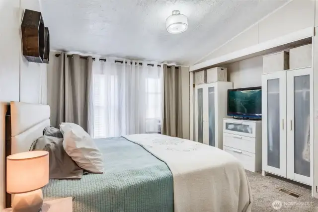 Another view of the primary suite showing full closet wall and calming, private ambiance.