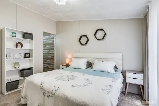 Spacious primary suite with soft natural light, neutral tones, and plenty of room to unwind.