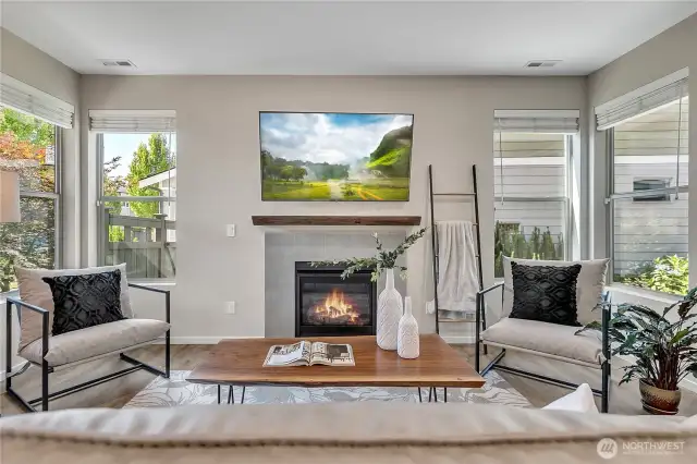 Gas fireplace and tons of natural light flood the living room.
