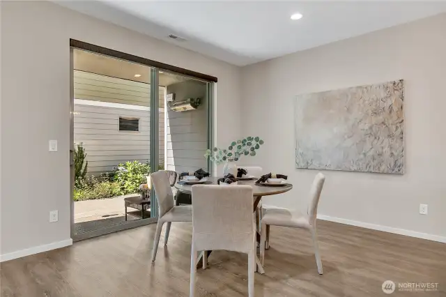 Kitchen eating and dining area overlooks the professionally landscaped sideyard.