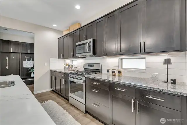 The kitchen leads to a well designed mud room with custom built-ins.