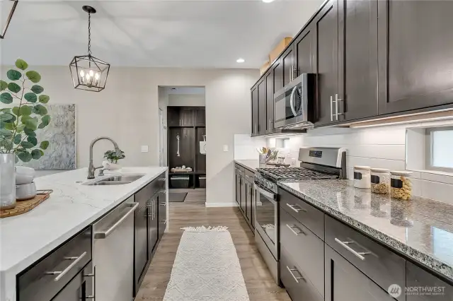 Stainless steel appliances and a large corner pantry round out the kitchen area.