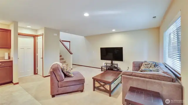 The living room is open and filled with natural light.