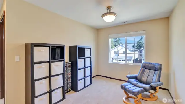 The den has a extra large window with lots of natural light.