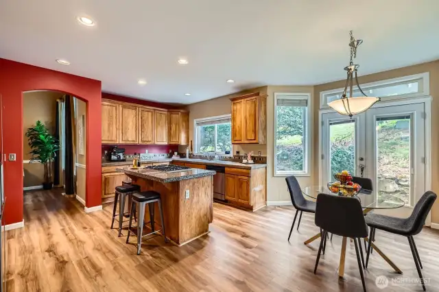 Off the kitchen are French doors leading to the patio for seamless indoor-outdoor living.